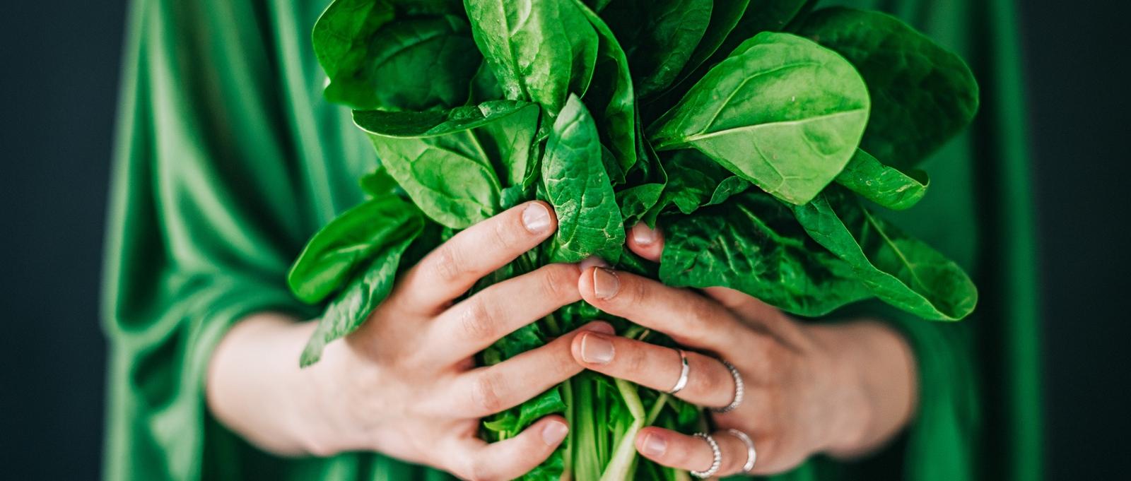 Woman holding spinach leaves