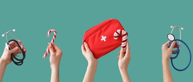 Various hands holding up red and white first aid kit and assorted medical items, along with red and white striped Christmas candy canes against a turquoise background.