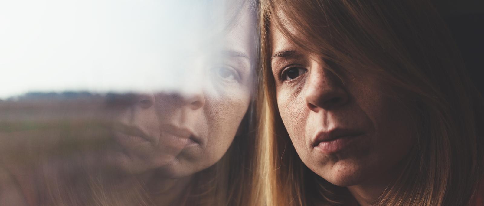 Woman on a train and sad